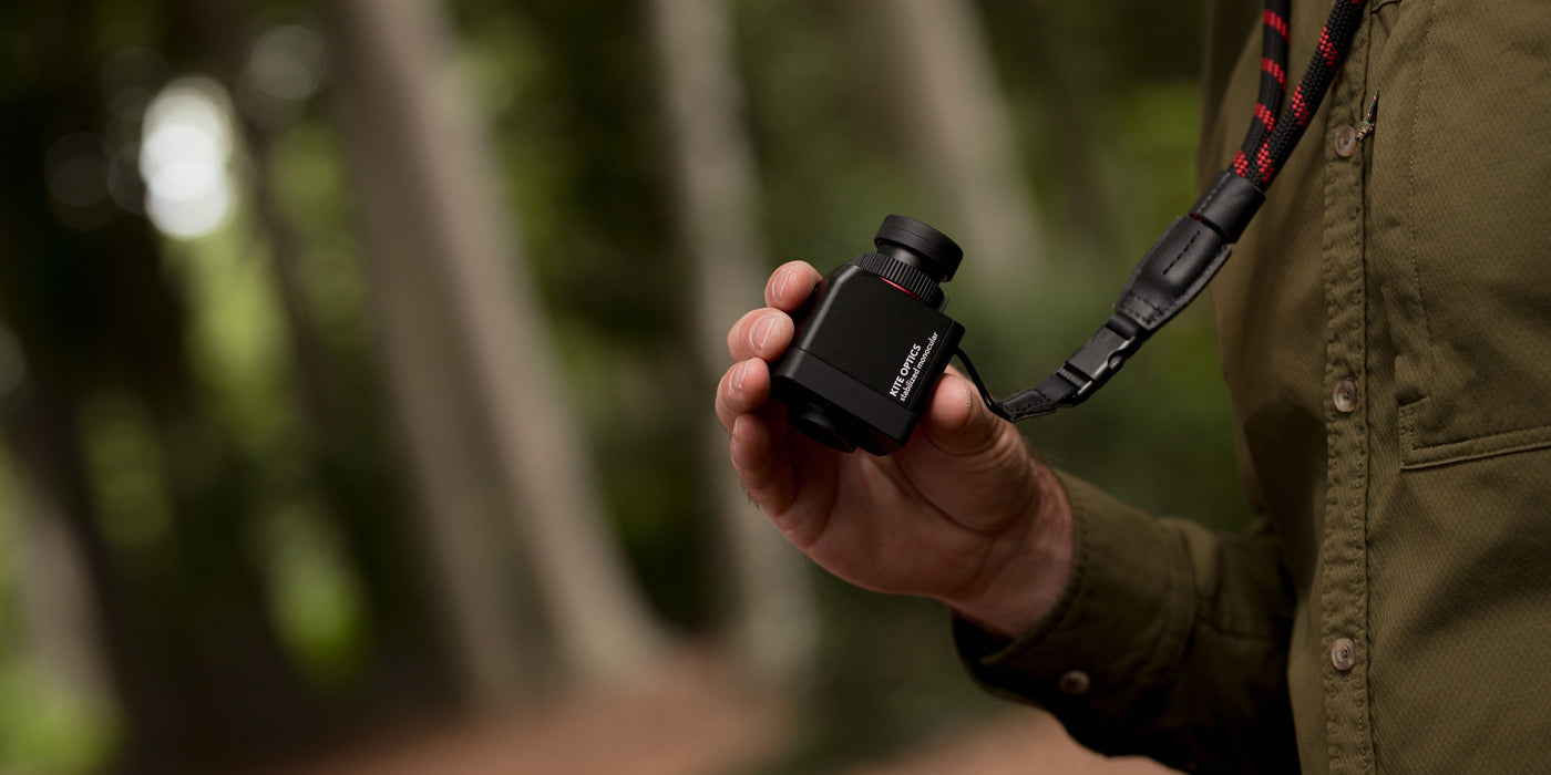 Kite Stabi One held in palm showing compact size with forest backdrop