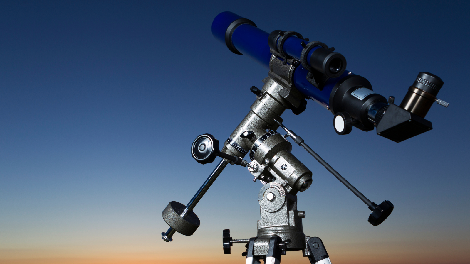 A telescope pointed at the night sky, illustrating telescope specifications for beginners