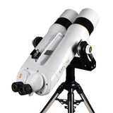 Explore Scientific BT 150mm ED Giant Binocular mounted on a fork mount and stainless steel tripod, angled upward at the sky with both 20mm eyepieces and the altitude friction knob visible