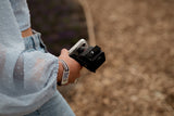 Close-up of woman holding Kite Stabi One with phone mount adapter at outdoor event