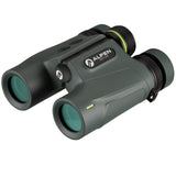 Alpen Apex XP 7x24 LRF binoculars objective end three-quarter view showing green-tinted multi-coated lenses, Alpen Optics badge, and strap lug attachment point